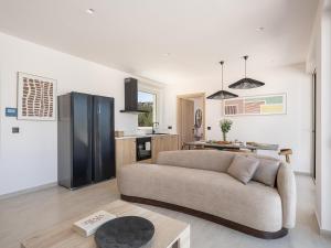 a living room with a couch and a kitchen at Casa Astra Agia Marina in Agia Marina Nea Kydonias