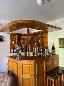 a large wooden bar with stools in a room at Panoramic Villa in Predeal in Predeal