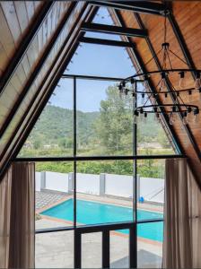 a view of a swimming pool from a window at Huzoor Aframe Gabala in Gabala +12 photos