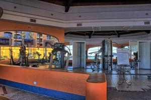 a gym with a treadmill and exercise equipment at Princesa -C206- Arcade Game -Experience Rocky Point- in Puerto Peñasco