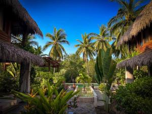 a view of a resort with palm trees at Villa Gato Surf Houses grande 4-6 personas, Starlink, AC, alberca, 50 m del spot La Saladita in La Salada
