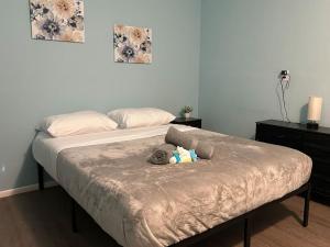 a stuffed elephant laying on a bed in a bedroom at Bright Private Room Ideal for Long or Short Stay Rm1 Shared home in Sarasota