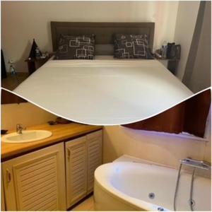 a bathroom with a bed with a sink and a tub at Villa Soazara in Koungou