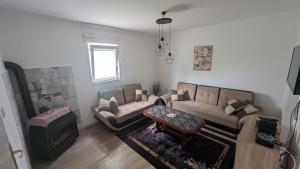 a living room with a couch and a table at Holiday Home DMD Sarajevo in Sarajevo