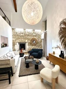 a living room with a stone wall at Maison de caractère - Jardin - Proche Angoulême in Saint-Yrieix-sur-Charente