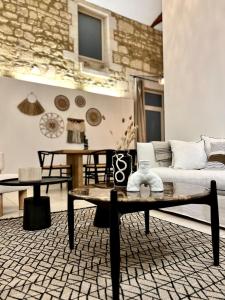 a living room with a couch and a table at Maison de caractère - Jardin - Proche Angoulême in Saint-Yrieix-sur-Charente