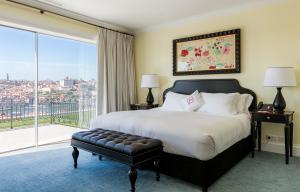 a bedroom with a large bed and a large window at The Yeatman in Vila Nova de Gaia