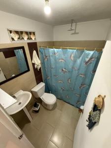 a bathroom with a dolphin shower curtain and a sink at Finca Marinilla in Marinilla