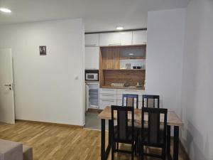 a kitchen with a table and chairs in a room at Apartman Marija II in Vrnjačka Banja