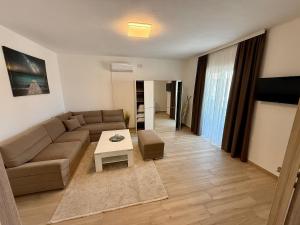 a living room with a couch and a table at Apartments Paris in Donji Štoj