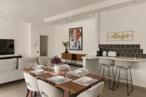 a kitchen and living room with a table and chairs at Como Hillview Apartment by Aura Luxury Collection in Como