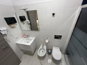 une salle de bain blanche avec toilettes et lavabo dans l'établissement Desire guest House, à Pise