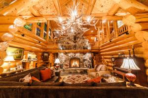 a living room with a fireplace in a log cabin at Coyote Bluff Estate in Somers