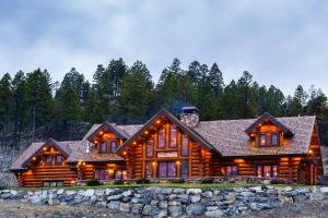 a large log cabin with a stone wall at Coyote Bluff Estate in Somers