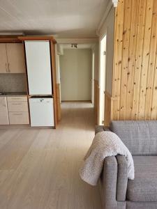 a living room with a couch and a kitchen at apartment calm and sunny area in Narvik