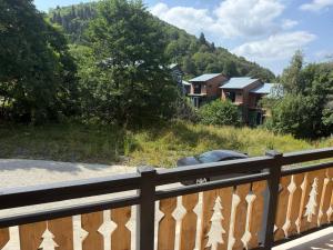 Un coche en un puente con una casa al fondo en Didveli Residence Apartment, en Bakuriani 1 foto más