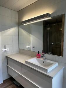 a bathroom with a sink and a mirror at Great Villa in Ólafsvík in Ólafsvík