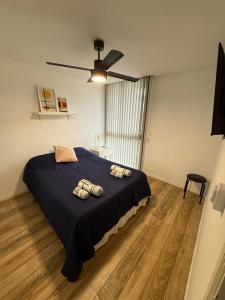 a bedroom with a bed with two pillows on it at Departamento en el centro - Lake Tower in Villa Carlos Paz +22 photos