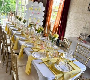 une longue table avec des serviettes jaunes et des verres dessus dans l'établissement Jackson Breezy Vacation and Venue Rental Barbados, à Saint Michael 21 autres photos