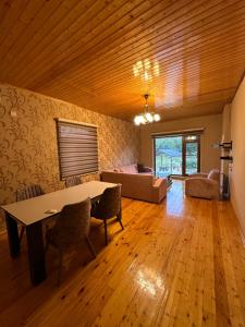 a living room with a table and a couch at Ashla guest house in Lankaran