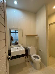 a bathroom with a toilet and a sink and a mirror at TIL DAWN Phuket in Karon Beach +35 photos