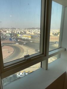 an open window with a view of a race track at غيمة in Hail