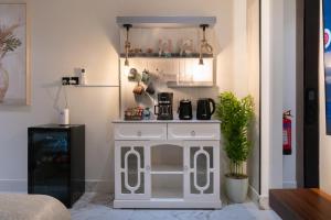a room with a white cabinet with a coffee maker at Söz suites in Al Khobar