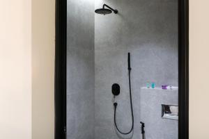 a shower with a shower head in a bathroom at Söz suites in Al Khobar +14 photos