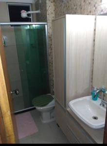 a bathroom with a shower and a toilet and a sink at Quarto em apartamento no cabula in Salvador +13 photos