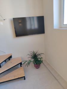 una stanza con due tavoli e una tv a muro di Stylish Duplex for 6, Central a Sarandë