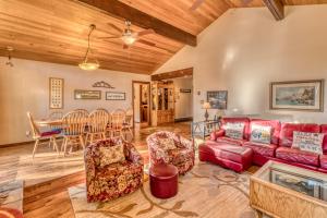 a living room with a red couch and a table at Golf Home 010 in Black Butte Ranch