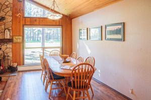 a dining room with a table and chairs and a window at Golf Home 010 in Black Butte Ranch