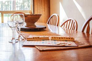 a wooden table with wine glasses and a napkin on it at Golf Home 010 in Black Butte Ranch