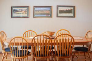 a dining room table and chairs with pictures on the wall at Golf Home 010 in Black Butte Ranch +21 photos