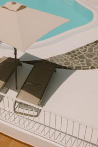 a table and an umbrella on top of a boat at Apartamentos Princesa Guayadeque in Puerto del Carmen