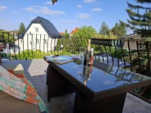 une table en verre avec une bouteille sur un balcon dans l'établissement Haabsburg Appartment Vienna 6 Personen, Balkon, voll ausgestattete Küche, Grün-Ruhelage am Stadtrand, gute Öffi Anbindung, à Vienne