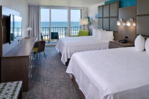 a hotel room with two beds and a balcony at Cabana Shores Hotel in Myrtle Beach +19 photos