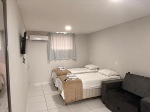 En eller flere senge i et værelse på BSH - Bangalô Smart Home