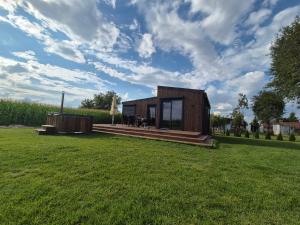 扎莫希奇Domek 104 B的草地上的一座小木房子