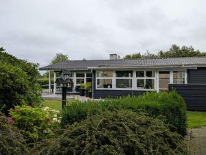 une maison avec beaucoup de fenêtres dans l'établissement Charming Cottage With Large Fenced Garden, à Løgstør