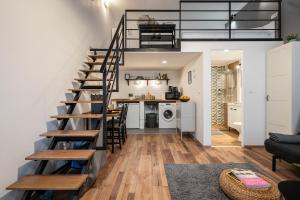 a staircase leading up to a living room and kitchen at Funhouse Dob in Budapest