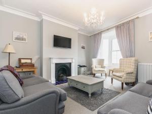 a living room with a couch and a fireplace at Frankland House in Whitby