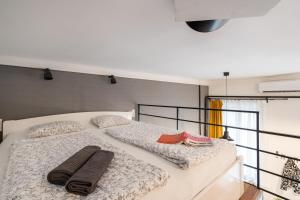 a bedroom with two beds with towels on them at Funhouse Dob in Budapest