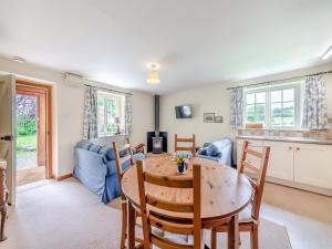 a kitchen and dining room with a table and chairs at Stable Cottage - 26032 in Wark