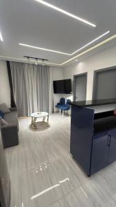 a living room with a grand piano and a couch at Flat In Elhambra in Hurghada