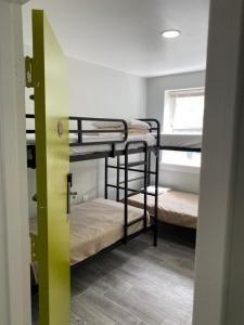 a room with three bunk beds and a window at Mayflower Hospitality Hostel in Washington, D.C. +10 photos