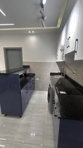 a large kitchen with black counter tops in a room at Flat In Elhambra in Hurghada