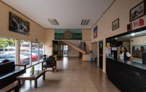 a woman is standing in the lobby of a store at Hotel Posada Anahuac in San Luis Potosí +23 photos