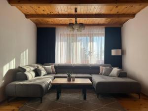 a living room with a couch and a table at Dom w górach Saganówka Beskidy in Międzybrodzie Bialskie +84 photos