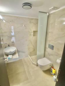 a bathroom with a toilet and a sink at Two Bedrooms Apartment - Chora Nestor Center in Khóra